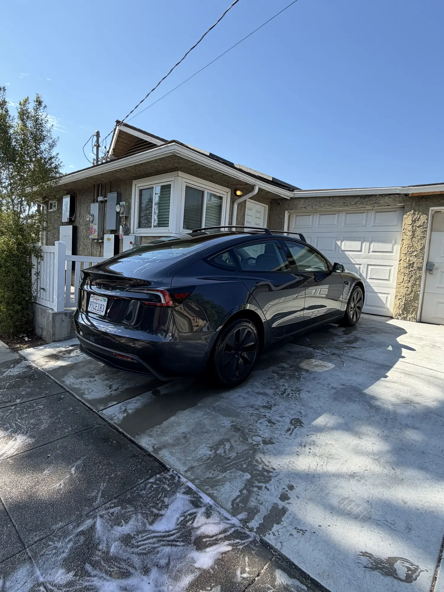 Tesla being washed in a home driveway