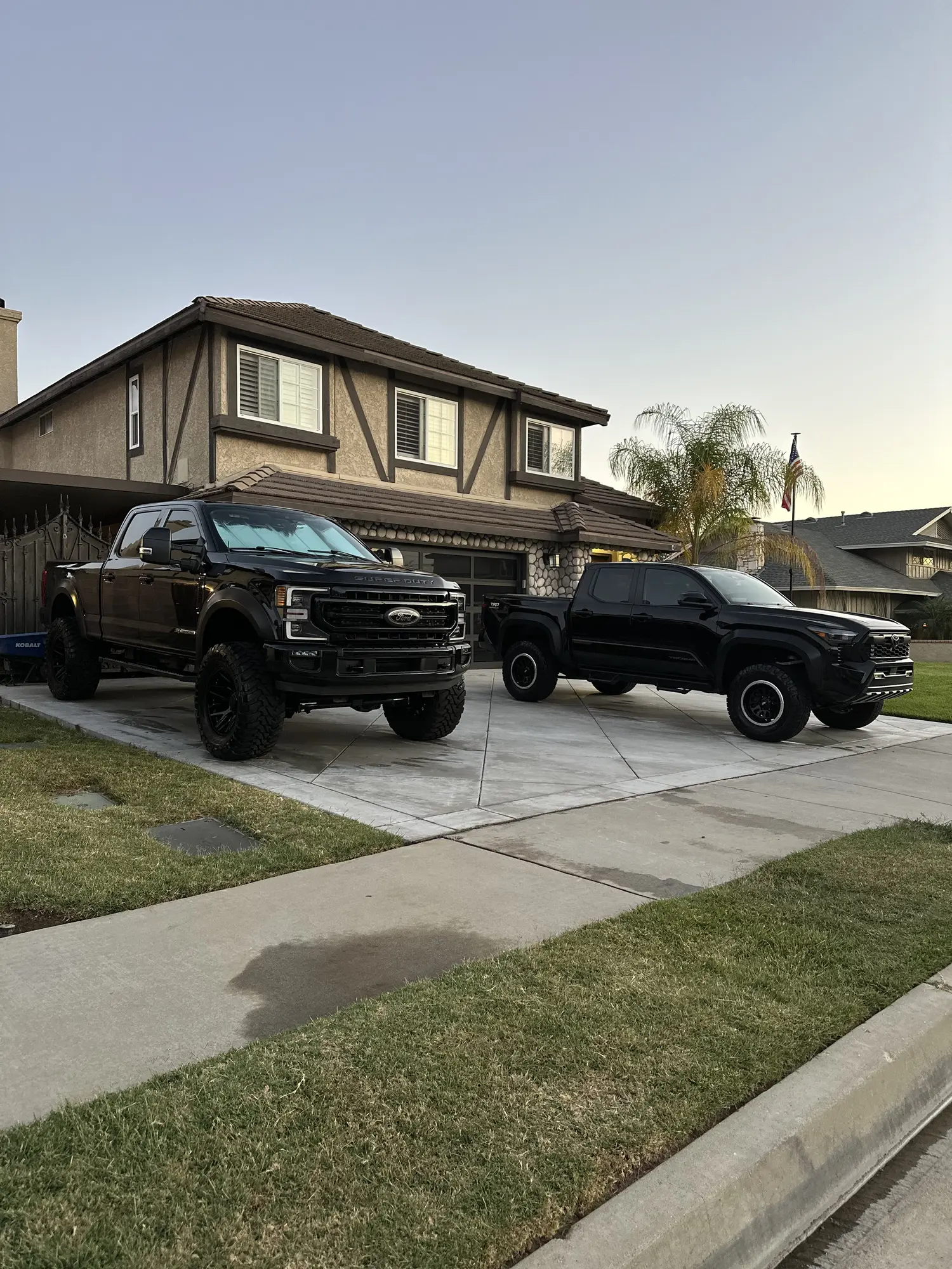 Two black pickup trucks after a mobile detail
