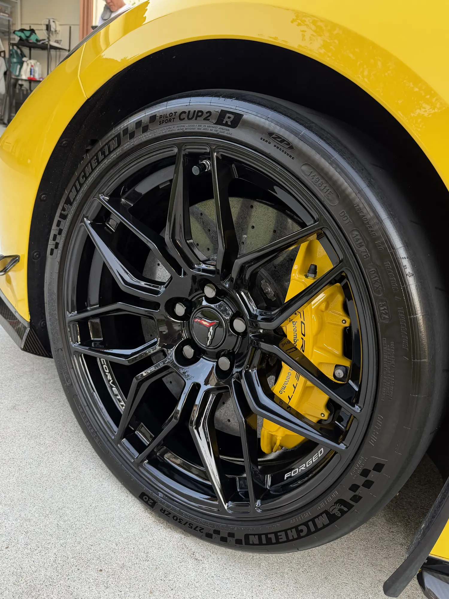 Black wheel with yellow calipers after a wheel detail
