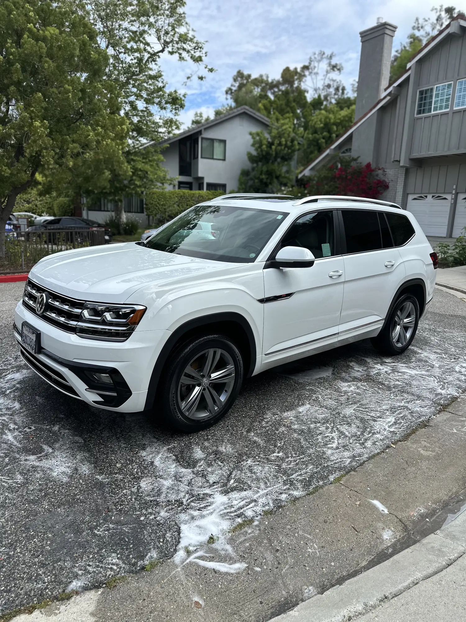 White SUV foam wash during an exterior detail