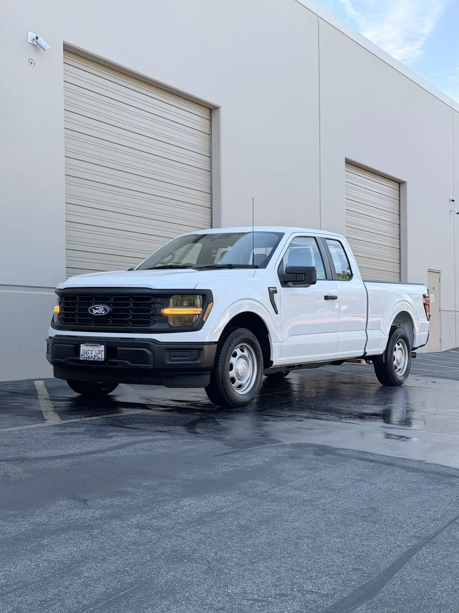 White Ford F-150 work truck after a wash